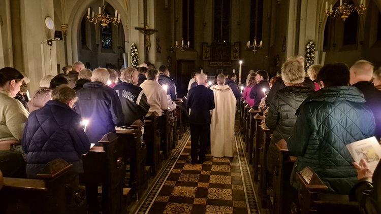 Processie met kaarslicht in de donkere kerk